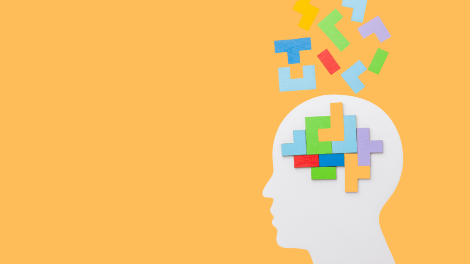 Witte silhouetvorm van een hoofd met kleurrijke puzzelstukken op een gele achtergrond, als beeld voor cognitieve ontwikkeling bij adolescenten.